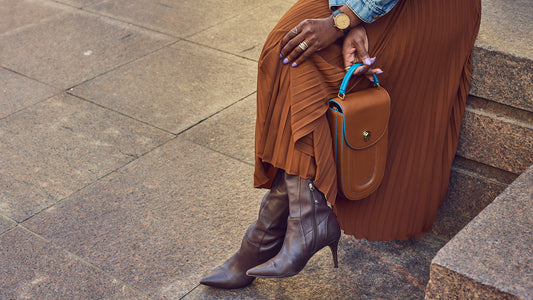 Fashion blogger Farotelle wearing a brown pleated skirt with brown leather boots and a brown handbag, Fall boots, monochrome style, Minneapolis blogger