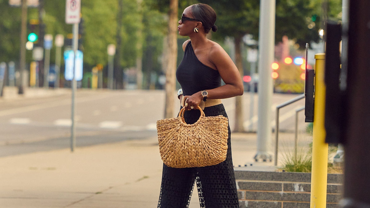 Black on black Summer outfit, how to style guipure pants, raffia accessories, large raffia tote, one-shoulder tops, Farotelle fashion blog, classic fashion