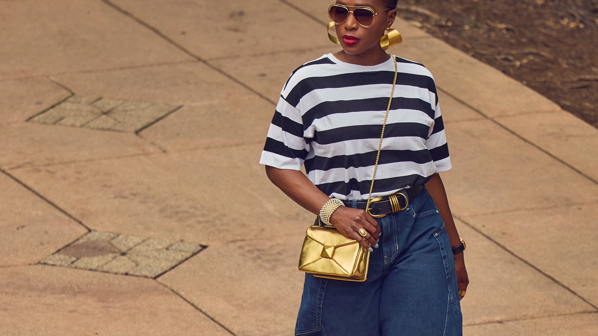 Barrel jeans outfit, jeans and a tee look, Farotelle, black fashion blogger, gold leather handbag, striped tee style, black blazer, street style fashion, elevated casual outfit, gold heels pumps, Free People Barrel Jeans, Ann Taylor top, Oversized earrings