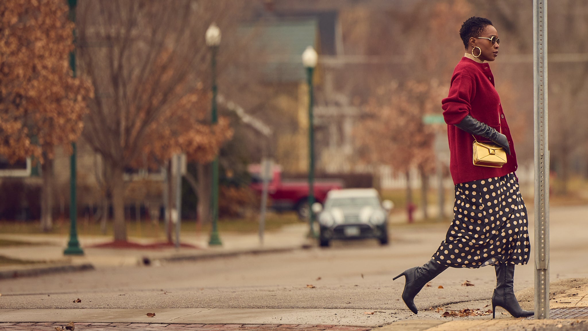 Fashion blogger Farotelle wearing a polka dot slip skirt with an oversized burgundy cardigan,  Winter outfit ideas, how to style a slip skirt, Minneapolis blogger, black fashion blogger, classy fashion, opera gloves style