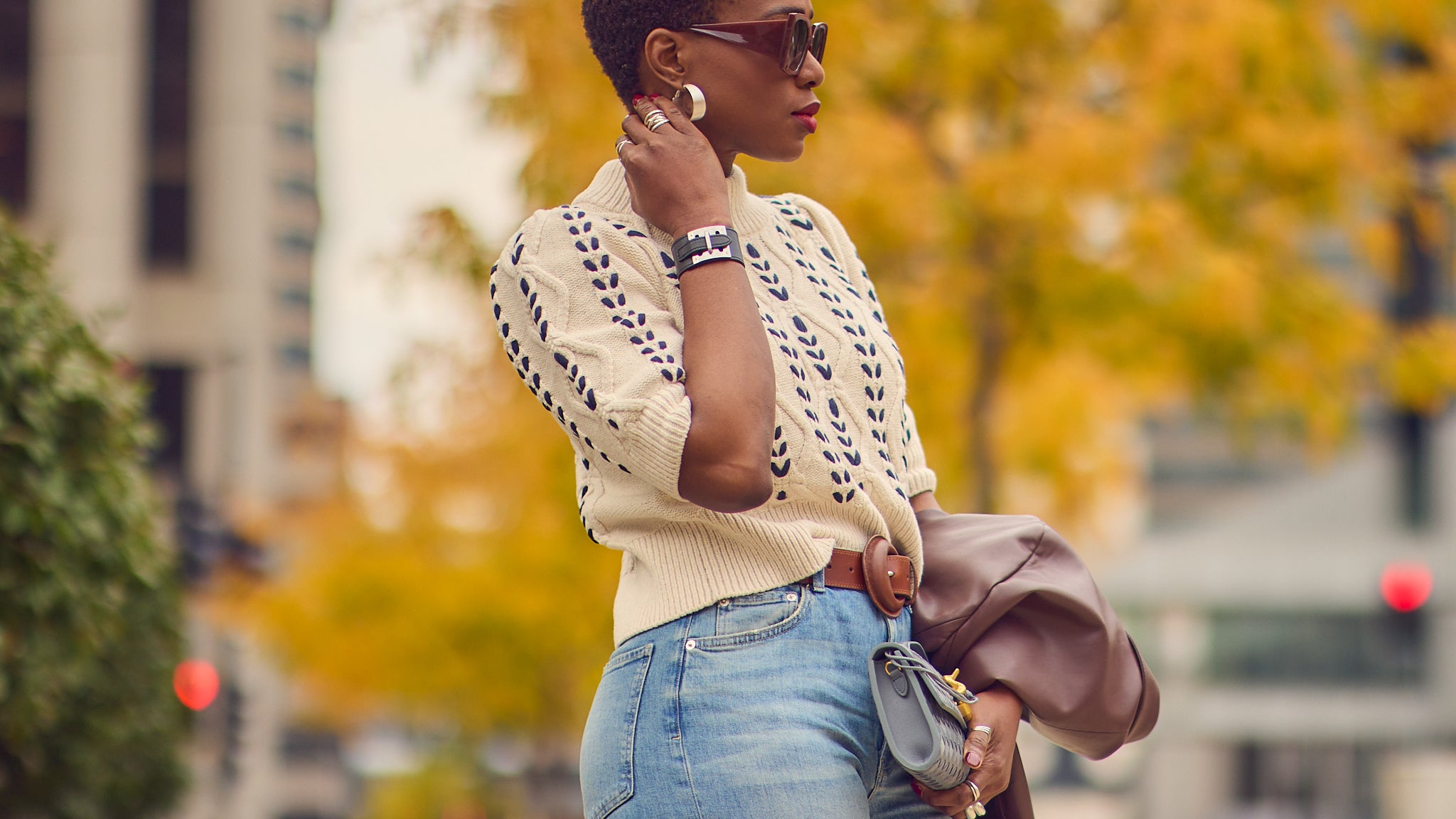 Fashion blogger Farotelle wearing a beige cable knit sweater with blue jeans, Fall casual outfit, oversized sunglasses style, Rails sweater, Hermes leather cuff bracelet, Minneapolis fashion blogger